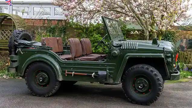 Full Side view of Classic Austin Champ in Army Green showing the brown seats and  no-door access
